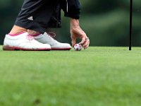 Barbara Grubkemeyer picks up her soccer themed golf ball after missing the hole by mere inches on the 5th hole in the final round of the Country Club of New Bedford women's four ball.  [ PETER PEREIRA/THE STANDARD-TIMES/SCMG ]