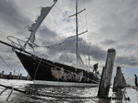 Mattapoisett Boatyard workmen try to stabilize the 55-foot sailboat Fearless on October 17, 2019, which washed into a wharf in Mattapoisett harbor due to the high overnight winds.  [ PETER PEREIRA/THE STANDARD-TIMES/SCMG ]