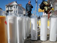 John Andrade, who lives close by, takes a moment to say a prayer as he walks by  the intersection of Tallman Street and Ashley Boulevard in the north end of New Bedford where two men were shot, one fataly, on Saturday evening.   [ PETER PEREIRA/THE STANDARD-TIMES/SCMG ]