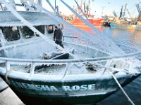 After arriving in New Bedford, MA on December 19, 2019, captain Mike Oliveira, walks across the frozen bow of the Menemsha Rose crab boat, in preparation to unload it's catch at Liberty Lobster in New Bedford, MA on a frigid morning. [ PETER PEREIRA/THE STANDARD-TIMES/SCMG ]