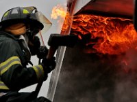 New Bedford firefighters battle a fire at a single family home on Tremont Street in New Bedford.  [ PETER PEREIRA/THE STANDARD-TIMES ]