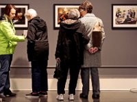 Donna Leary, left, helps her mother, Dorothy Yates with her nametag as Dorothy Lowney speaks with her mother Doretta Lowney while looking at photos of President Obama taken by Pete Souza. Members of ALZ (Alzheimer's Association) who suffer from mild Alzheimer's and their family, take a closer look at photographs by Presidential photographer Pete Souza, while touring the New Bedford Art Museum as part of the ALZ Meet Up program.  [ PETER PEREIRA/THE STANDARD-TIMES ]