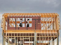 Workmen are framed by their creation, as they construct a new home in Padanaram.  [ PETER PEREIRA/THE STANDARD-TIMES/SCMG ]