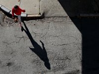 The morning sun casts a long shadow as a woman steps off of the curb to cross School Street in downtown New Bedford.  [ PETER PEREIRA/THE STANDARD-TIMES/SCMG ]