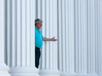 Mike DeBarros of J J Best Insurance is framed by the colonnade of the J J Best Banc  & Co. building on N. Water Street in downtown New Bedford, as he takes a customer call on his wireless headset.  [ PETER PEREIRA/THE STANDARD-TIMES/SCMG ]