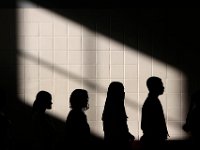 A ray of light through the window casts itself across the back wall, as students wait to read on the importance of Veterans Day during the annual Veternas Day ceremony held at the Roosevelt Middle School in the south end of New Bedford.  [ PETER PEREIRA/THE STANDARD-TIMES/SCMG ]