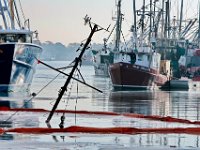 Tucker-Roy salvage crew move toward the sunk small lobster boat, Moonraker, which sank overnight while docked in New Bedford harbor.  [ PETER PEREIRA/THE STANDARD-TIMES ]