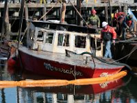 Tucker-Roy salvage crews, lift the small lobster boat, Moonraker, from the bottom after it sank overnight while docked in New Bedford harbor.  [ PETER PEREIRA/THE STANDARD-TIMES ]