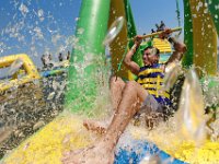 Domingo Garcia takes shelter from the sweltering heat by enjoying himself at the newly opened Whoa Zone water park installed off of East Beach in New Bedford.