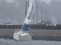 A sail boat runs aground into the Bridge Street causeway in Dartmouth, MA on October 27, 2021 as nor'easter storm slams into the region.