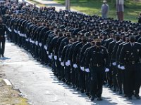 City, State and Regional police officers and firefighters, march toward the Saunders Dwyer Funeral Home in New Bedford, to pay their final respects to New Bedford police officer Sgt. Michael Cassidy, 52, who passed away after a battle with COVID-19.