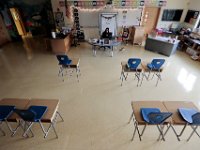 An empty classroom greets Courtney Lima as she makes her way into her classroom on her fist day as a teacher. Courtney Lima who attended the Taylor School in New Bedford as a student for grades K-6, returns for her first day of school, this time as a third grade teacher. Ms. Lima will be teaching third graders virtually this year, as part of the Distance Learning Academy for students who opted to stay home for this school year.  PHOTO PETER PEREIRA