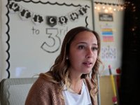 Courtney Lima takes a look at her computer monitor as her students begin logging in for the first time on their first day of school, and her first day as a teacher. Courtney Lima who attended the Taylor School in New Bedford as a student for grades K-6, returns for her first day of school, this time as a third grade teacher. Ms. Lima will be teaching third graders virtually this year, as part of the Distance Learning Academy for students who opted to stay home for this school year.  PHOTO PETER PEREIRA