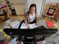 Courtney Lima interacts with her studetns remotely on their first day of school, and her first day as a teacher. Courtney Lima who attended the Taylor School in New Bedford as a student for grades K-6, returns for her first day of school, this time as a third grade teacher. Ms. Lima will be teaching third graders virtually this year, as part of the Distance Learning Academy for students who opted to stay home for this school year.  PHOTO PETER PEREIRA