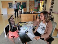 New Bedford curriculum data and assessment manager for math, Joshua Almeida, and Taylor School principal Rafaela Defigueiredo-Spence drop int, as new techer, Courtney Lima, gives her students the thumbs up as they conduct class virtually. Courtney Lima who attended the Taylor School in New Bedford as a student for grades K-6, returns for her first day of school, this time as a third grade teacher. Ms. Lima will be teaching third graders virtually this year, as part of the Distance Learning Academy for students who opted to stay home for this school year.  PHOTO PETER PEREIRA