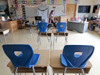 Courtney Lima puts on her mask and prepares to go to lunch. Courtney Lima who attended the Taylor School in New Bedford as a student for grades K-6, returns for her first day of school, this time as a third grade teacher. Ms. Lima will be teaching third graders virtually this year, as part of the Distance Learning Academy for students who opted to stay home for this school year.  PHOTO PETER PEREIRA