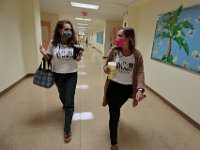 Third grade teachers, Gina Salsiha and Courtney Lima walk towards the teachers room to enjoy lunch. Courtney Lima who attended the Taylor School in New Bedford as a student for grades K-6, returns for her first day of school, this time as a third grade teacher. Ms. Lima will be teaching third graders virtually this year, as part of the Distance Learning Academy for students who opted to stay home for this school year.  PHOTO PETER PEREIRA