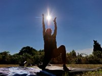 The sun rises in the background as innstructor Tracy Clarke, leads participants in a yoga classs as part of the Summer Yoga Series held at the DNRT  Slocums River Reserve on Horseneck Road in Dartmouth.   [ PETER PEREIRA/THE STANDARD-TIMES/SCMG ]