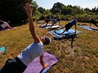 Instructor Tracy Clarke, leads participants in a yoga classs as part of the Summer Yoga Series held at the DNRT  Slocums River Reserve on Horseneck Road in Dartmouth.   [ PETER PEREIRA/THE STANDARD-TIMES/SCMG ]