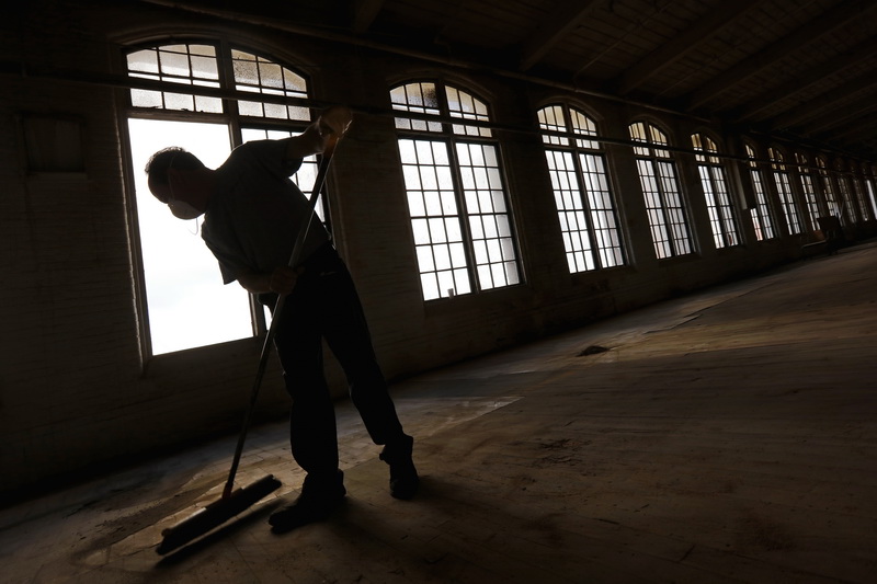 Al Grilo sweeps the floors of a mill being renovated in the south end of New Bedford. 
[ PETER PEREIRA/THE STANDARD-TIMES/SCMG ]