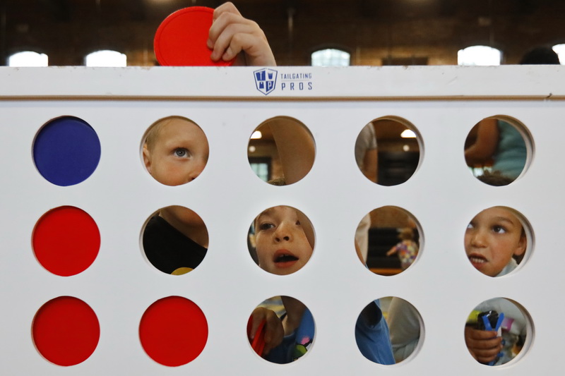 Children play a giant Connect 4 game during Family Fun Day at the Andrea McCoy Recreation Center on Hillman Street in New Bedford. PHOTO PETER PEREIRA