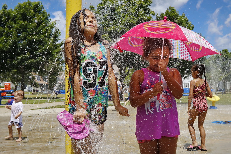 Kids take shelter from the heat in the water park portion of Harrington Park on Court Street in New Bedford, MA as the region braces for a heat wave scheduled to roll across the region this weekend.  PHOTO PETER PEREIRA