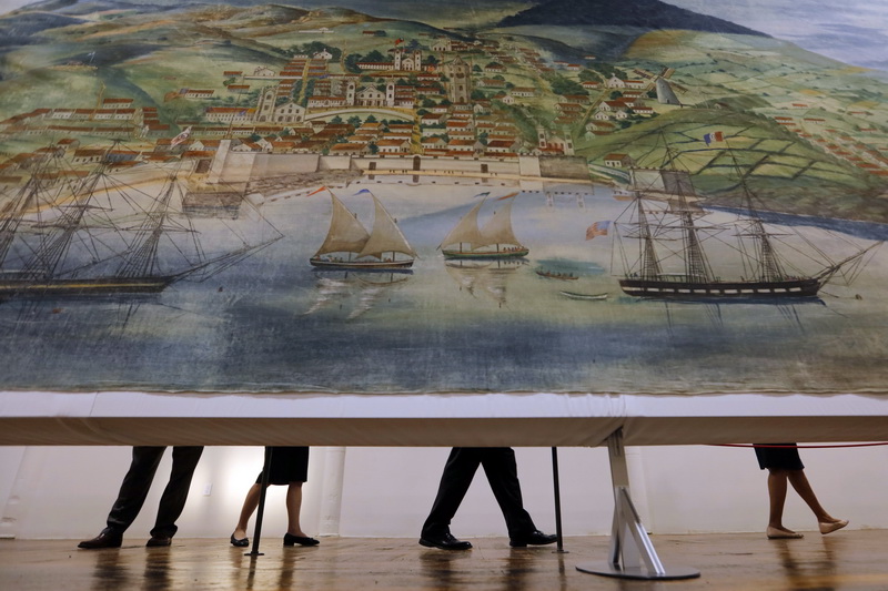 Guets walk past a scene depicting Horta in the Azores, as the Whaling Museum's 1848 Grand Panorama of a Whaling Voyage 'Round the World, is open for viewing for the first time at the Kilburn Mill at Clarks Cove in the south end of New Bedford, MA.  Created by Benjamin Russell and Caleb Purrington in 1848 and measuring 1,275' long, it is considered to be the longest painting in the world, and has not been exhibitied in over 50 years PHOTO PETER PEREIRA