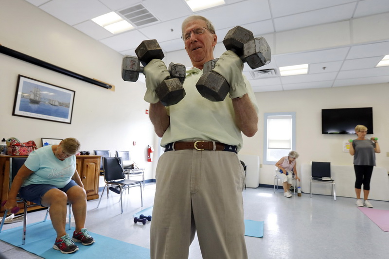 Tom Reidler uses weights during the Strength & Flex session at Dartmouth Council on Aging on Dartmouth Street in Dartmouth, MA. PHOTO PETER PEREIRA