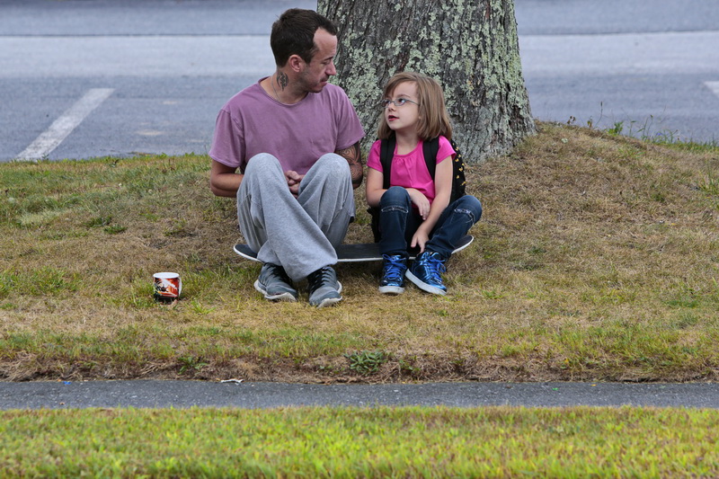Joseph Cloutier and his daughter Alexa Cloutier, 7, enjoy some conversation while sitting on his skateboard, waiting for the school bus to pick up Alexa on Washington Street in Fairhaven, MA. PHOTO PETER PEREIRA
