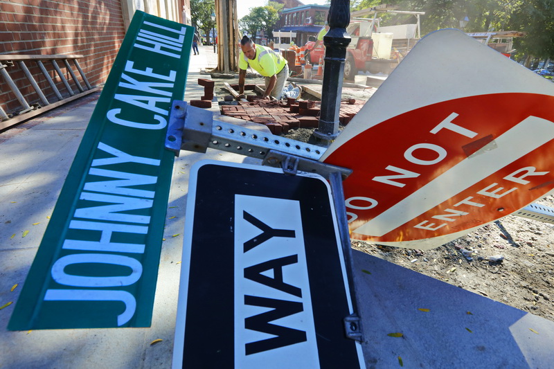 Joe Camara installs the new brickwork lining the sidewalk on Union Street, in front of the site of the new Paul Cuffe Park on Johnny Cake Hill in downtown New Bedford, MA. PHOTO PETER PEREIRA