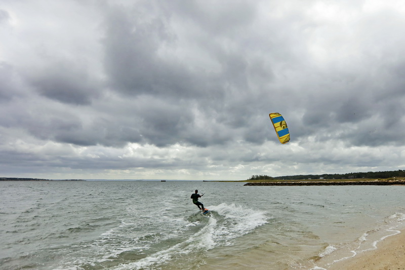 George Luber goes kitesurfing on a windy morning on a beach in Marion, MA. PHOTO PETER PEREIRA