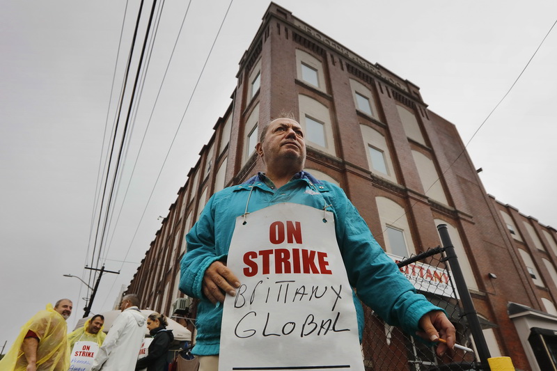 Joe Faria, who works in shipping and receiving, along with fellow workers strike in front of the Brittany Global Technologies plant in the south end of New Bedford, MA. PHOTO PETER PEREIRA