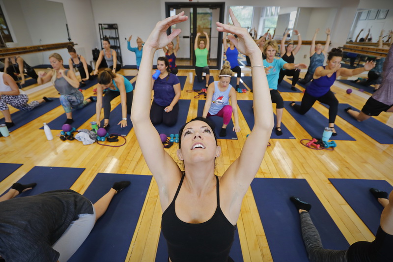 Sara Crook and fellow participants stretch during a morning session at The Barre Fitness Studio on Union Street in New Bedford which combines elements of ballet, yoga and pilates. PHOTO PETER PEREIRA