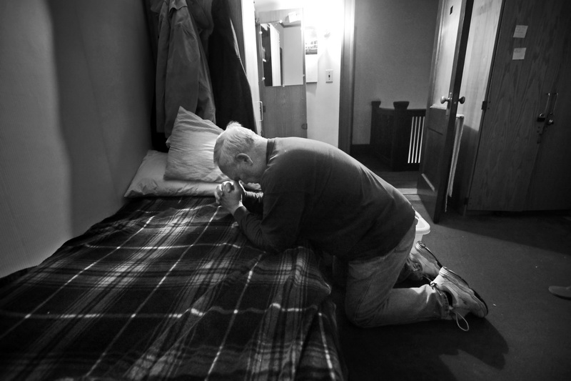 After an early morning (5am) wake up, David McCarthy, an Air Force veteran dealing with alcohol addiction, prays on his bed at the Veterans Transition House in New Bedford.  After relapsing four months ago, Mr. McCarthy decided to check back into the VTH in his quest to stay sober.  This is part of a bigger project I am working on veterans dealing with addiction and suicide.  PHOTO PETER PEREIRA