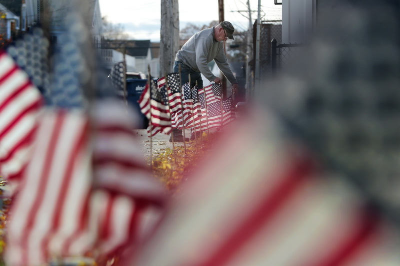 Gary Lavalette places American flags around the Veterans Park on Route 6 in Fairhaven, MA in preparation for Veterans Day.  PHOTO PETER PEREIRA