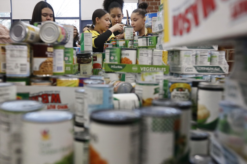 Normandin Middle School students sort and prepare food baskets to give to the needy for Thanksgiving, with cans they collected throught the school year and turkeys donated by the Friendly Sons of St. Patrick. PHOTO PETER PEREIRA