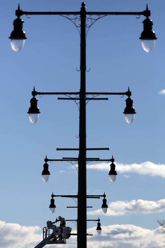 Nick Prisco installs a new light post on Route 18 in New Bedford, MA as part of phase two renovations to the raodway which connects the north to the south end of the city.  PHOTO PETER PEREIRA