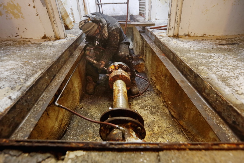Alex Oliveira of Oliveira Painting, finds himself deep in the depths of a fishing boat using a pneumatic pick to chisel old paint off of the drive shaft of a fishing boat in preparation for a fresh coat of paint. PHOTO PETER PEREIRA