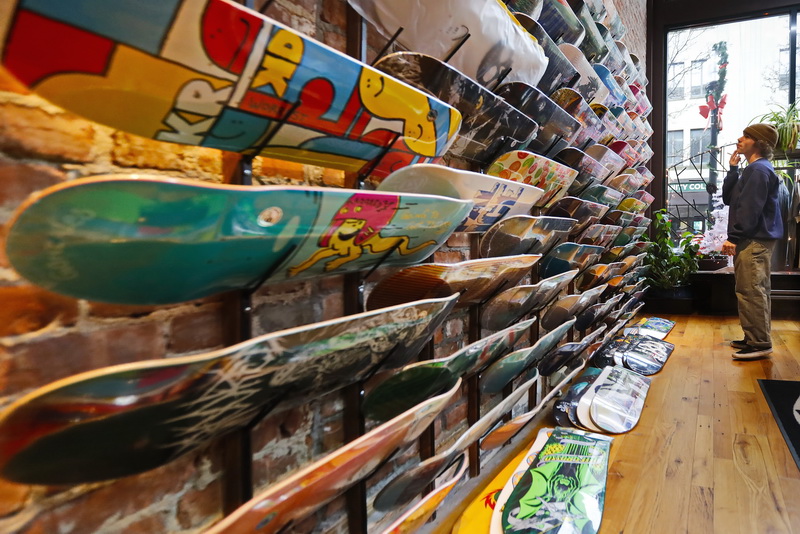 Patrick Mooney is faced with a tough decision, as he takes advantage of a Christmas gift card to pick a new skateboard deck at Solstice in downtown New Bedford, MA. PHOTO PETER PEREIRA