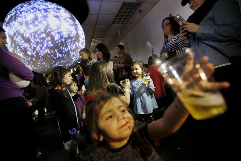 Kids and parents alike attend the unique Noon Year's Eve celebration at the Buttonwoon Park Zoo in New Bedford, MA toasting with apple juice and dancing to with a countdown happening at noon.  PHOTO PETER PEREIRA