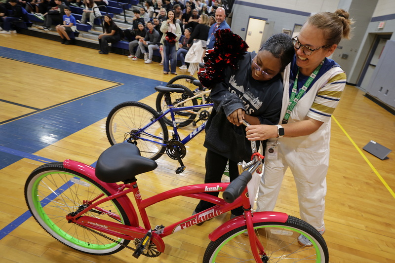 Genesis Costa is overcome with emotion as she hugs councilor Patty Keefe upon hearing she had been awarded a bicycle at the Normandin Middle School in New Bedford, MA. Normandin attendance officer Darryle Morris worked with Johnson & Johnsonto secure the bicycles which were awarded as part of the school's effort to recognize and celebrate student progress, attendance, and perseverance. PHOTO PETER PEREIRA