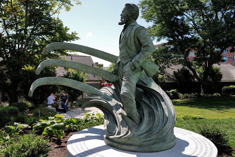 Two women enjoy lunch under the shade, in the company of the newly erected Herman Melville statue in front of the Seamen's Bethel in New Bedford, MA on September 8, 2026. PHOTO PETER PEREIRA