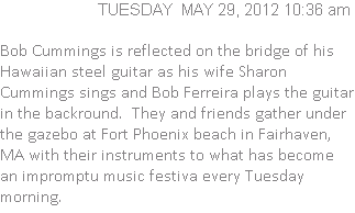 Bob Cummings is reflected on the bridge of his Hawaiian steel guitar as his wife Sharon Cummings sings and Bob Ferreira plays the guitar in the backround.  They and friends gather under the gazebo at Fort Phoenix beach in Fairhaven, MA with their instruments to what has become an impromptu music festiva every Tuesday morning.