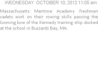 Massachusetts Maritime Academy freshmen cadets work on their rowing skills passing the looming bow of the Kennedy training ship docked at the school in Buzzards Bay, MA.