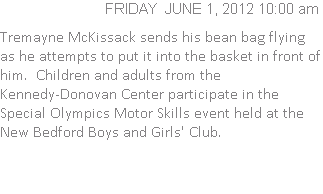 Tremayne McKissack sends his bean bag flying as he attempts to put it into the basket in front of him.  Children and adults from the Kennedy-Donovan Center participate in the Special Olympics Motor Skills event held at the New Bedford Boys and Girls' Club.