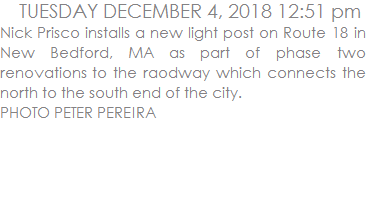 Nick Prisco installs a new light post on Route 18 in New Bedford, MA as part of phase two renovations to the raodway which connects the north to the south end of the city.  PHOTO PETER PEREIRA