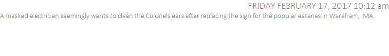 A masked electrician seemingly wants to clean the Colonels ears after replacing the sign for the popular eateries in Wareham,  MA.