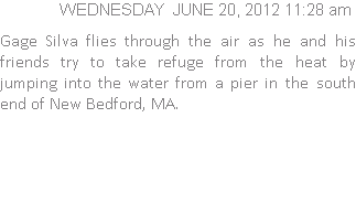 Gage Silva flies through the air as he and his friends try to take refuge from the heat by jumping into the water from a pier in the south end of New Bedford, MA.