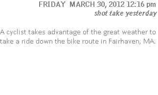 A cyclist takes advantage of the great weather to take a ride down the bike route in Fairhaven, MA.