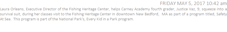 Laura Orleans, Executive Director of the Fishing Heritage Center, helps Carney Academy fourth grader, Justice Vaz, 9, into a survival suit, during her classes visit to the Fishing Heritage Center in downtown New Bedford,  MA as part of a program titled, Safety At Sea.  This program is part of the National Park's, Every Kid in a Park program.  